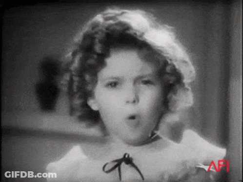 A Black And White Photo Of A Little Girl Making A Funny Face GIF