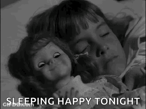 A Black And White Photo Of A Little Girl Sleeping With A Doll And The Words `` Sleeping Happy Tonight '' . GIF