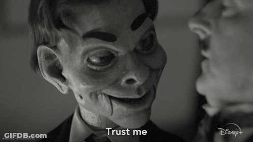 A Black And White Photo Of A Man And A Puppet That Says " Trust Me " GIF