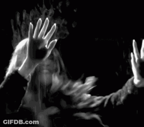 A Black And White Photo Of A Man And A Woman Behind A Glass Door . GIF