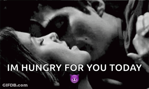 A Black And White Photo Of A Man And A Woman Kissing . GIF
