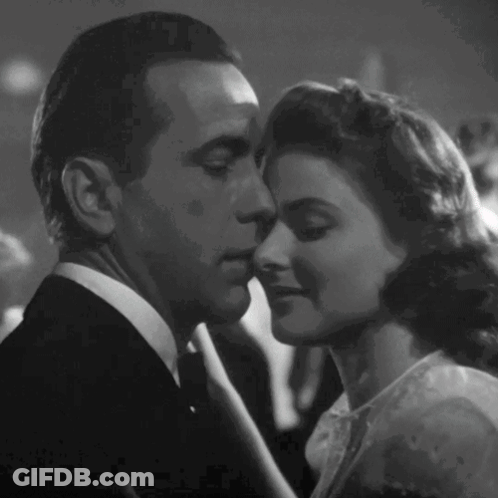 A Black And White Photo Of A Man And A Woman Kissing GIF