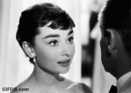 Black And White Photo Of Man And Woman Looking At Each Other GIF