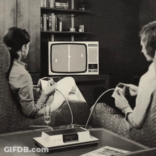 A Black And White Photo Of A Man And A Woman Playing A Video Game GIF