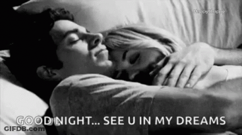 A Black And White Photo Of A Man And A Woman Sleeping In A Bed . GIF