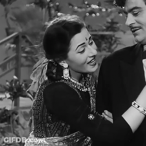 A Black And White Photo Of A Man And A Woman Smiling GIF