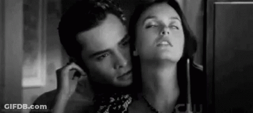 A Black And White Photo Of A Man And A Woman Talking On A Phone . GIF