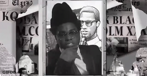A Black And White Photo Of A Man And A Woman With A Newspaper That Says Lm X GIF