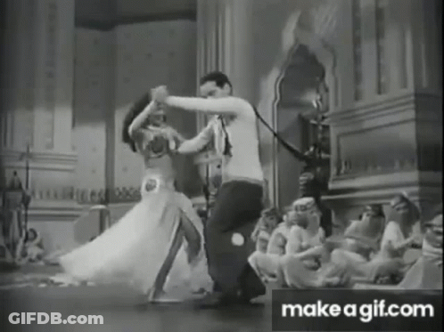 A Black And White Photo Of A Man And Woman Dancing In A Room . GIF