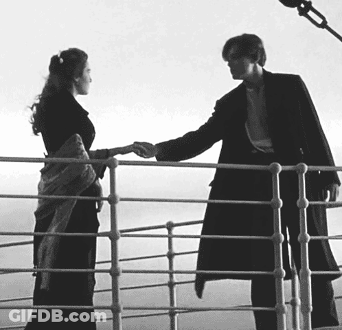 A Black And White Photo Of A Man And Woman Holding Hands On A Railing GIF