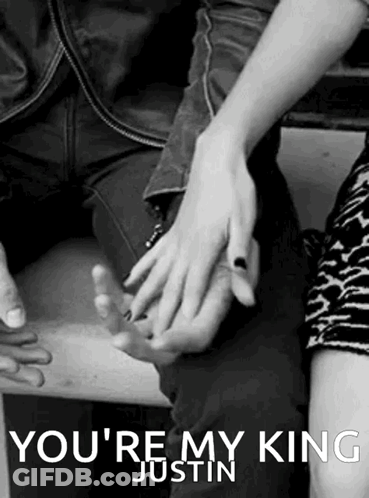 A Black And White Photo Of A Man And Woman Holding Hands With The Caption " You 'Re My King Justin " . GIF