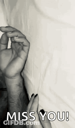 A Black And White Photo Of A Man And Woman Holding Hands With The Words `` Miss You '' . GIF