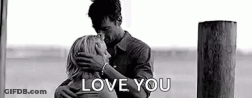 A Black And White Photo Of A Man And Woman Hugging Each Other And The Words `` Love You '' . GIF