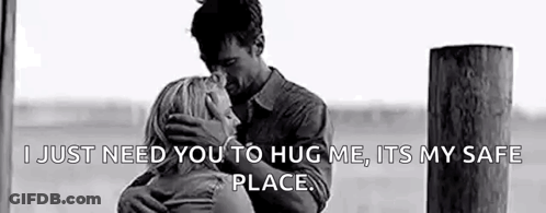 A Black And White Photo Of A Man And Woman Hugging Each Other . GIF