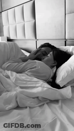 A Black And White Photo Of A Man And Woman Hugging GIF