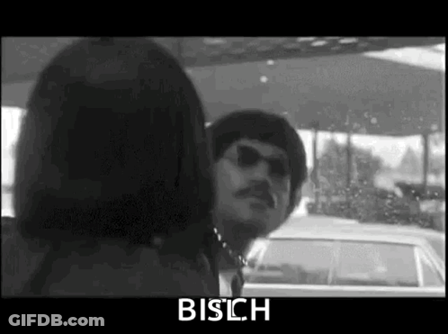 A Black And White Photo Of A Man And Woman In A Car . GIF