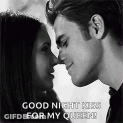 A Black And White Photo Of A Man And Woman Kissing Each Other . GIF
