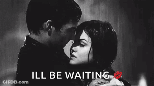 A Black And White Photo Of A Man And Woman Kissing In The Rain With The Words Ill Be Waiting Below Them GIF