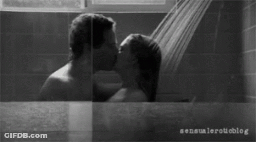 A Black And White Photo Of A Man And Woman Kissing GIF