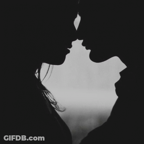 A Black And White Photo Of A Man And Woman Kissing With The Words " A Kiss Goodnight " Below Them GIF