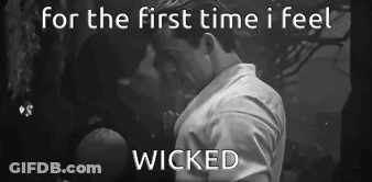 A Black And White Photo Of A Man And Woman Kissing With The Words For The First Time I Feel Wicked GIF