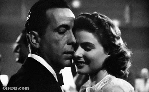 A Black And White Photo Of A Man And Woman Kissing . GIF