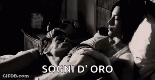 A Black And White Photo Of A Man And Woman Laying In Bed Together . GIF