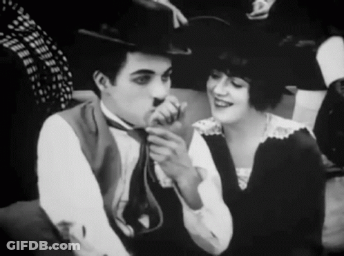 A Black And White Photo Of A Man And Woman GIF