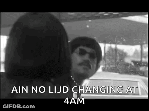 A Black And White Photo Of A Man And Woman Standing Next To Each Other In A Car . GIF