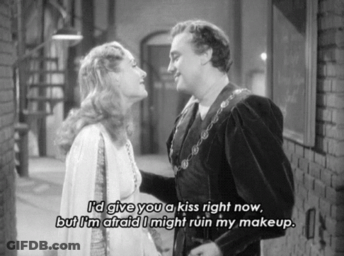 A Black And White Photo Of A Man And Woman With A Caption That Says " I 'D Give You A Kiss Right Now GIF