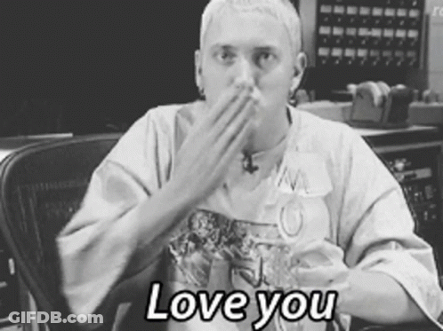 A Black And White Photo Of A Man Covering His Mouth With His Hand And The Words " Love You " Below Him GIF