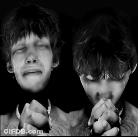 A Black And White Photo Of A Man Crying And Another Man Praying GIF
