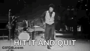 A Black And White Photo Of A Man Dancing On A Stage In Front Of A Microphone . GIF