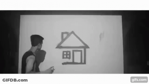 A Black And White Photo Of A Man Drawing A House On A Wall GIF