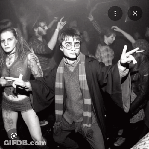 A Black And White Photo Of A Man Dressed As Harry Potter Giving The Peace Sign GIF