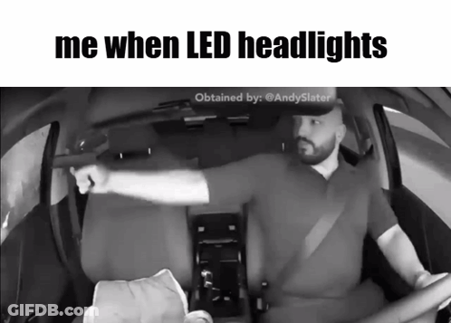 A Black And White Photo Of A Man Driving A Car With The Caption Me When Led Headlights GIF