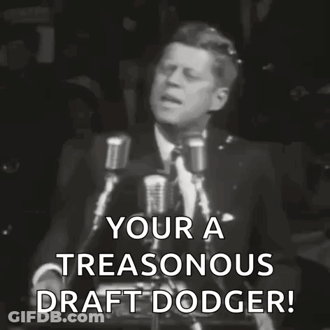 A Black And White Photo Of A Man Giving A Speech That Says Your A Treasonous Draft Dodger . GIF