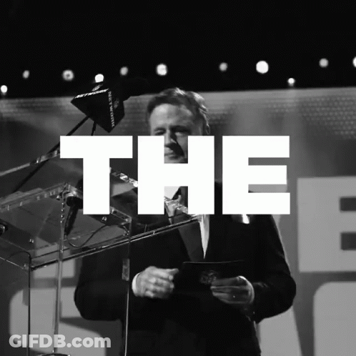 A Black And White Photo Of A Man Giving A Speech With The Word The Above Him GIF