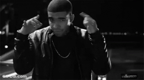 A Black And White Photo Of A Man Giving The Middle Finger While Standing In Front Of A Car . GIF