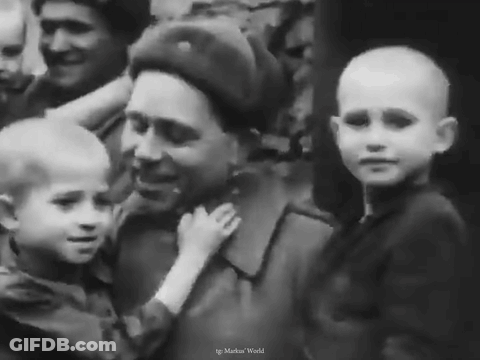 A Black And White Photo Of A Man Holding A Child GIF