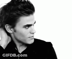 A Black And White Photo Of A Man Holding His Neck GIF
