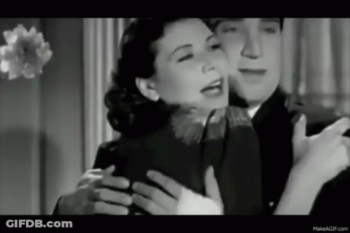 A Black And White Photo Of A Man Hugging A Woman . GIF