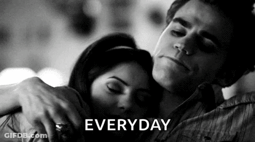 A Black And White Photo Of A Man Hugging A Woman With The Word Everyday Written Above Them GIF