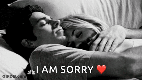 A Black And White Photo Of A Man Hugging A Woman With The Words I Am Sorry Above Them GIF