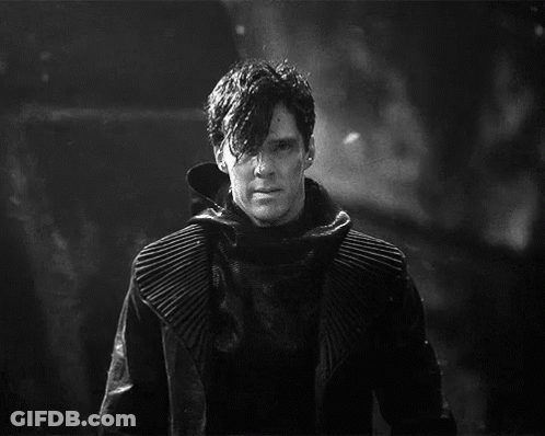 A Black And White Photo Of A Man In A Black Coat GIF