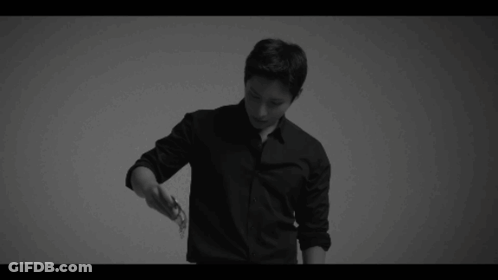 A Black And White Photo Of A Man In A Black Shirt And Black Pants . GIF