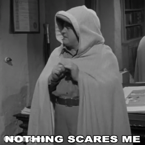 A Black And White Photo Of A Man In A Cape With The Caption " Nothing Scares Me " GIF