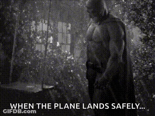 A Black And White Photo Of A Man In A Cape With The Caption " When The Plane Lands Safely ... " GIF