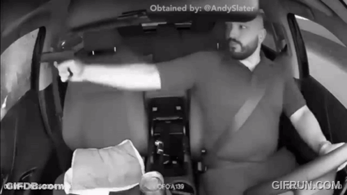 A Black And White Photo Of A Man In A Car With Gifrun.com At The Bottom GIF
