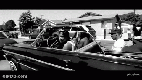A Black And White Photo Of A Man In A Car With The Words Yellow On The Bottom Right GIF